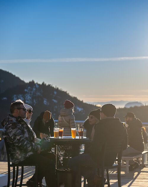 a group of people sitting on the deck